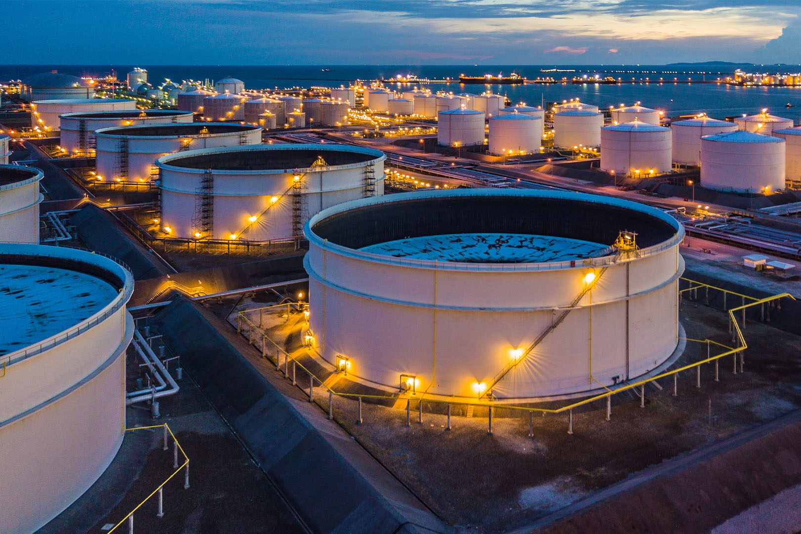 Aerial top view storage tank farm at night, Tank farm storage chemical petroleum petrochemical refinery product at oil terminal